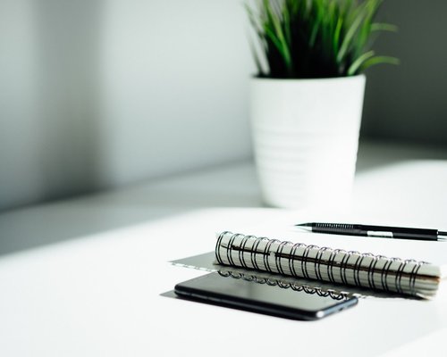 A desk setup with documents and a pen