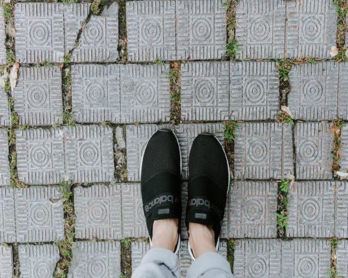 Close up of comfortable walking shoes on a pavement
